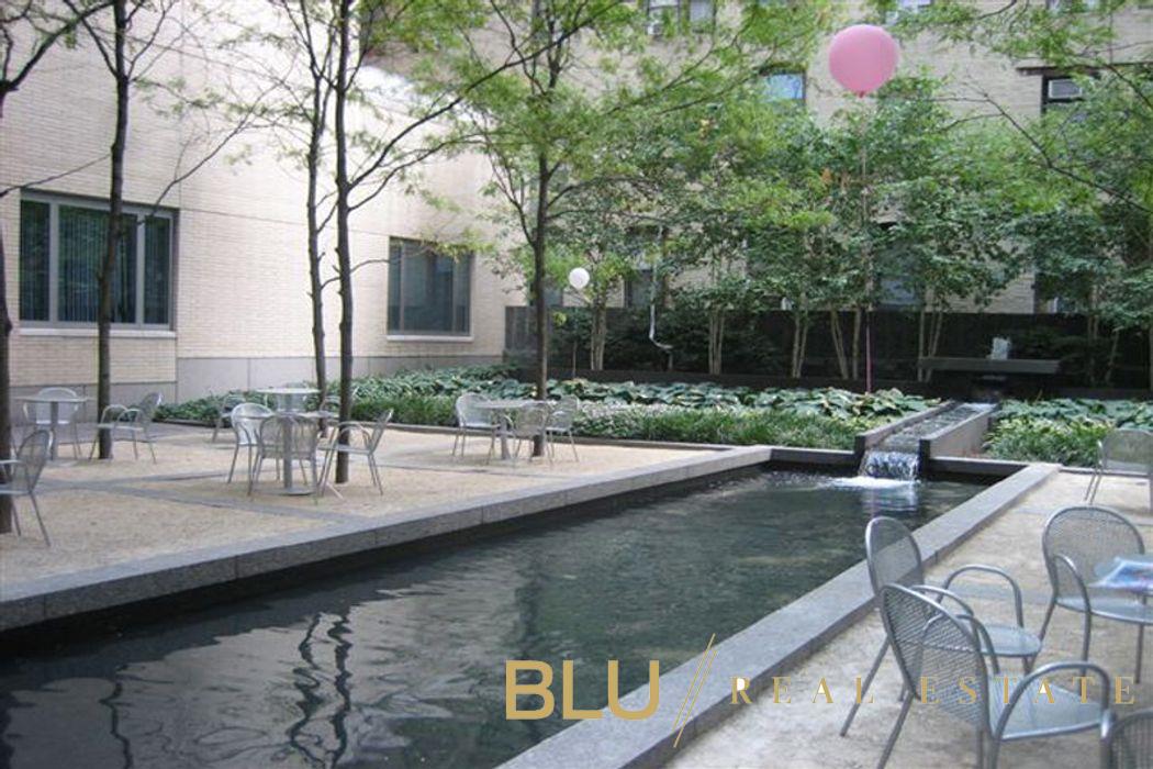 220 Riverside Boulevard, Unit 15M Manhattan, NY 10069 - Photo 5 of 11 a view of a swimming pool with a patio and a garden