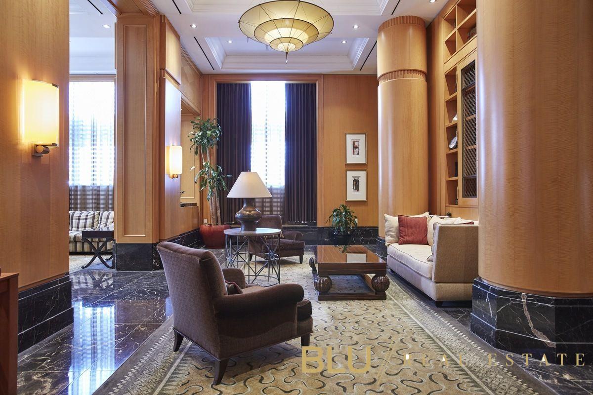 220 Riverside Boulevard, Unit 15M Manhattan, NY 10069 - Photo 7 of 11 a living room with furniture and a large window