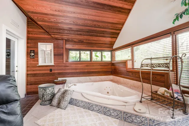 a bathroom with a tub and mirror