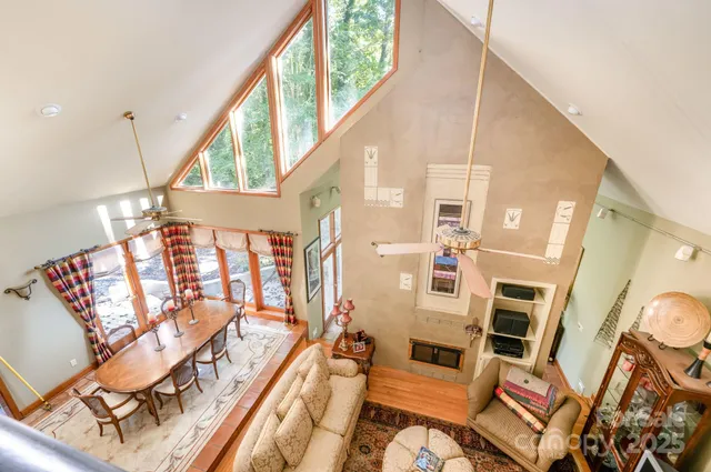 a view of a living room with furniture and a floor to ceiling window