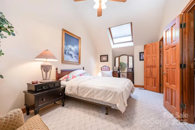 a bedroom with a bed dresser and a window