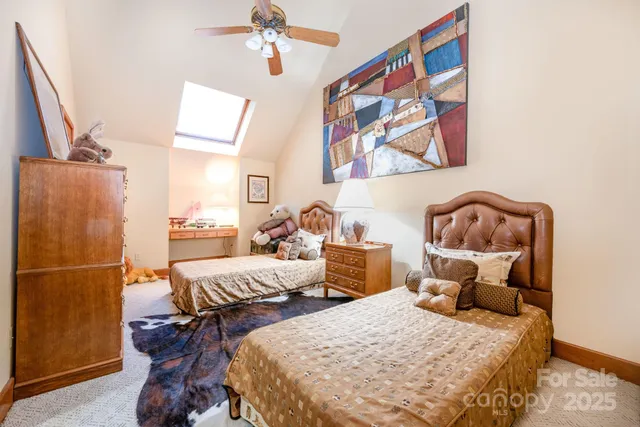 a bedroom with two beds and painting on the wall