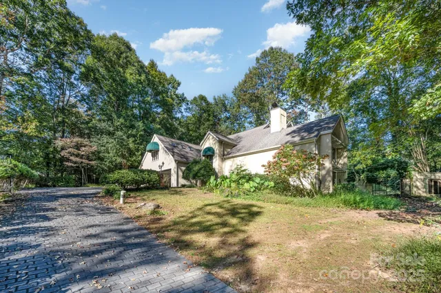 a view of a house with a yard and sitting area