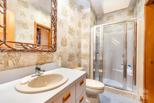 a bathroom with a sink toilet and shower