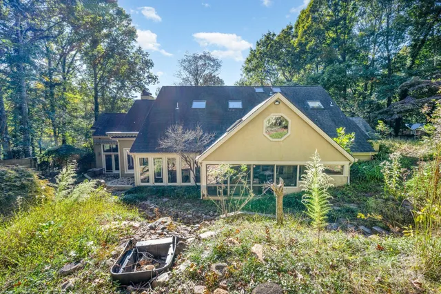 a backyard of a house with yard and outdoor seating