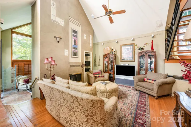 a living room with fireplace furniture and a floor to ceiling window