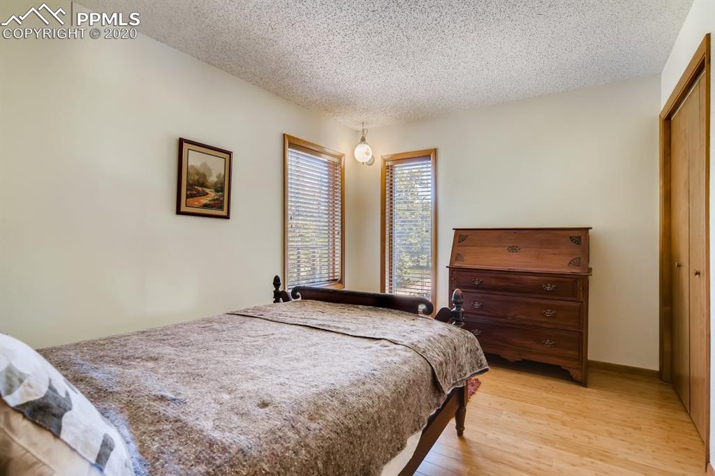 247 Pinewood Road Florissant, CO 80816 - Photo 11 of 39 a bedroom with a bed and a flat screen tv