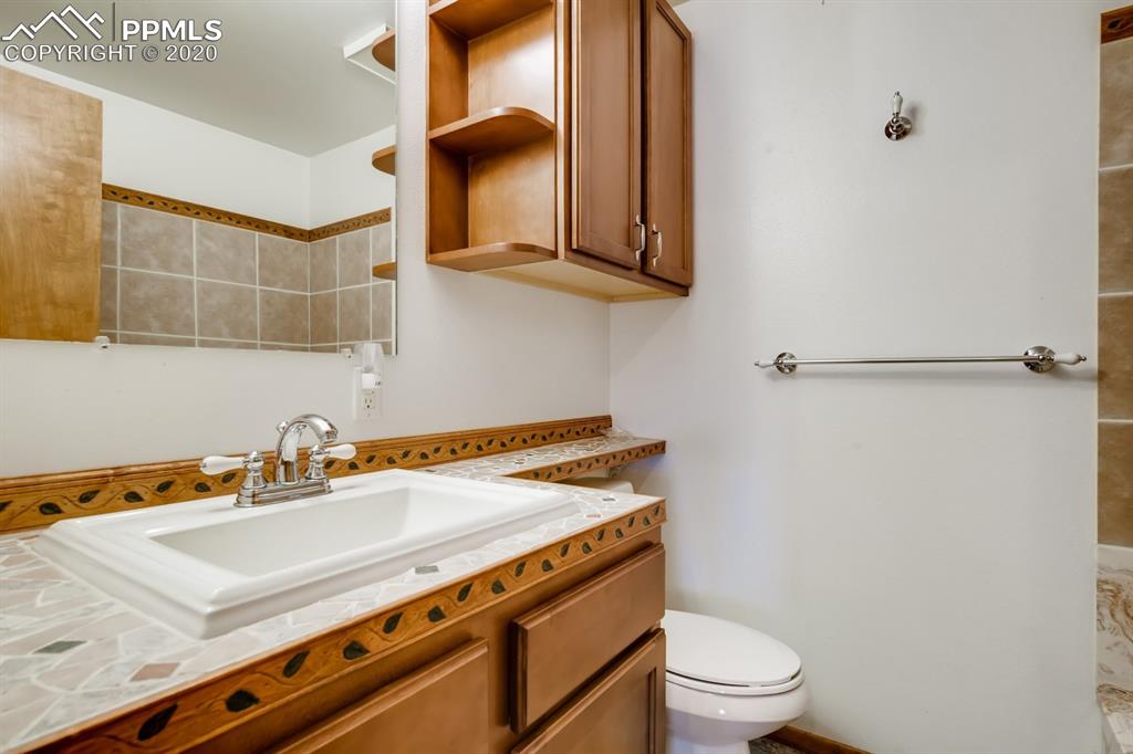 247 Pinewood Road Florissant, CO 80816 - Photo 12 of 39 a bathroom with a sink a toilet and mirror