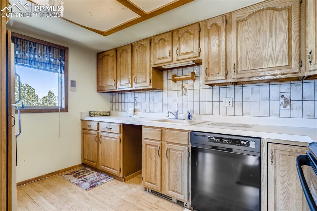 247 Pinewood Road Florissant, CO 80816 - Photo 13 of 39 a kitchen with stainless steel appliances granite countertop a sink stove and cabinets