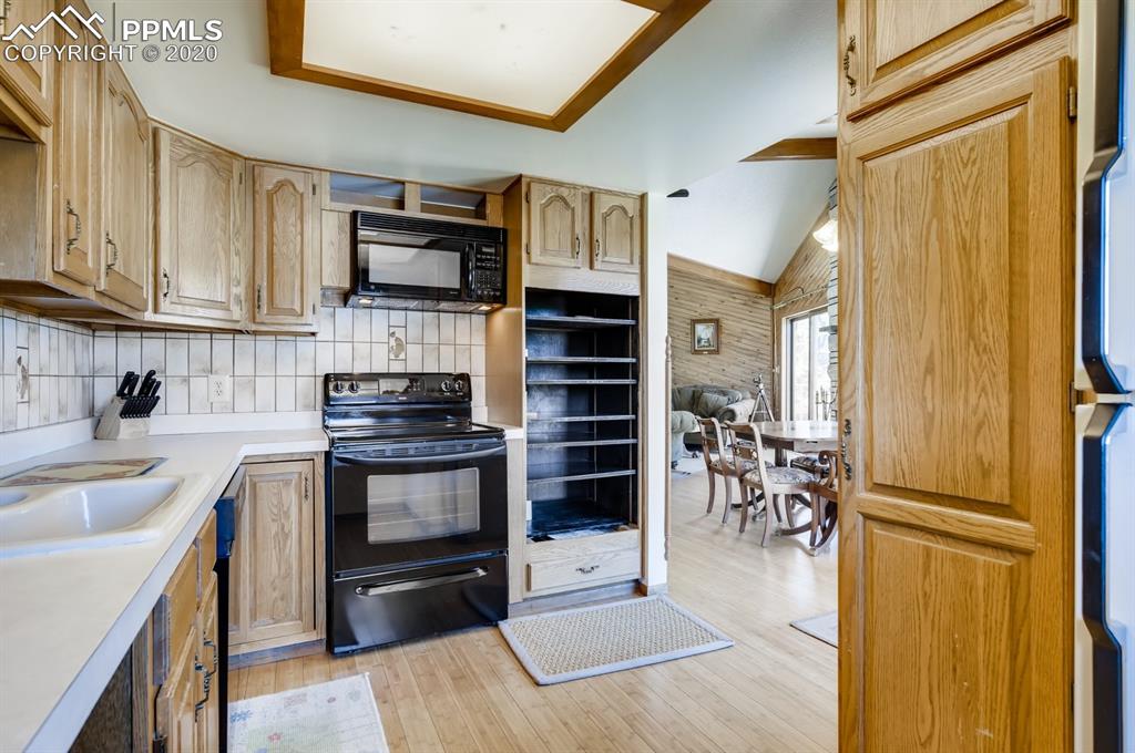 247 Pinewood Road Florissant, CO 80816 - Photo 14 of 39 a kitchen with stainless steel appliances a stove a sink and a refrigerator