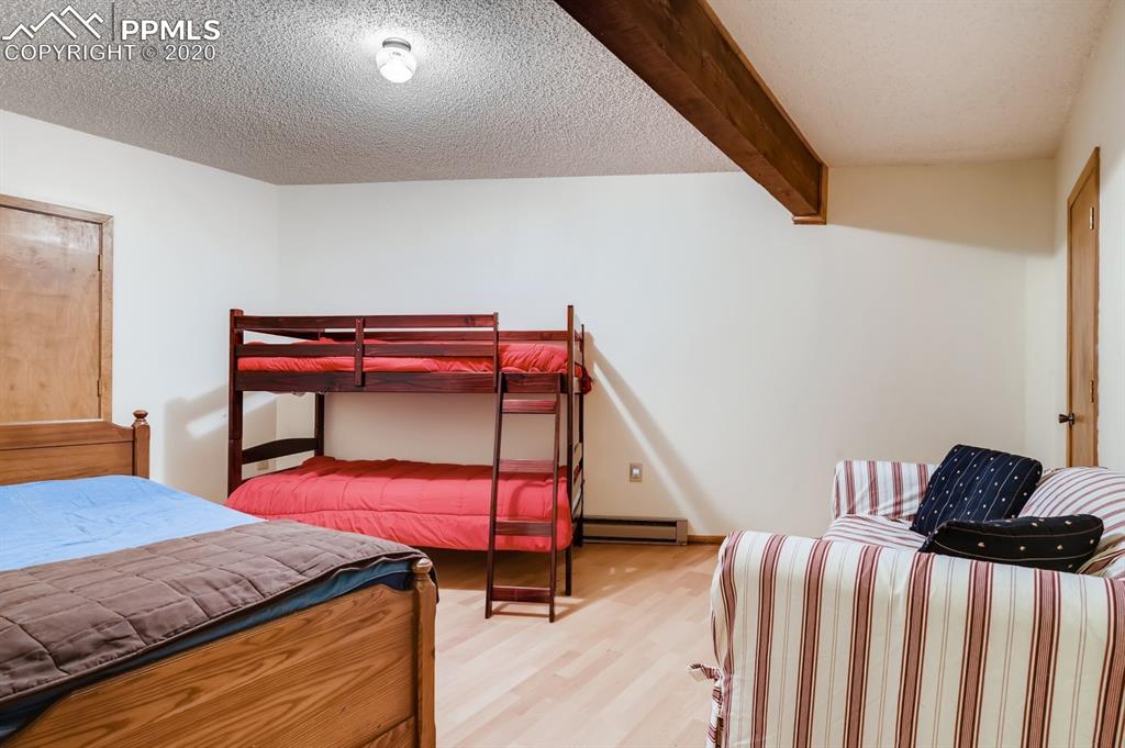 247 Pinewood Road Florissant, CO 80816 - Photo 17 of 39 a bedroom with a bed and a dresser