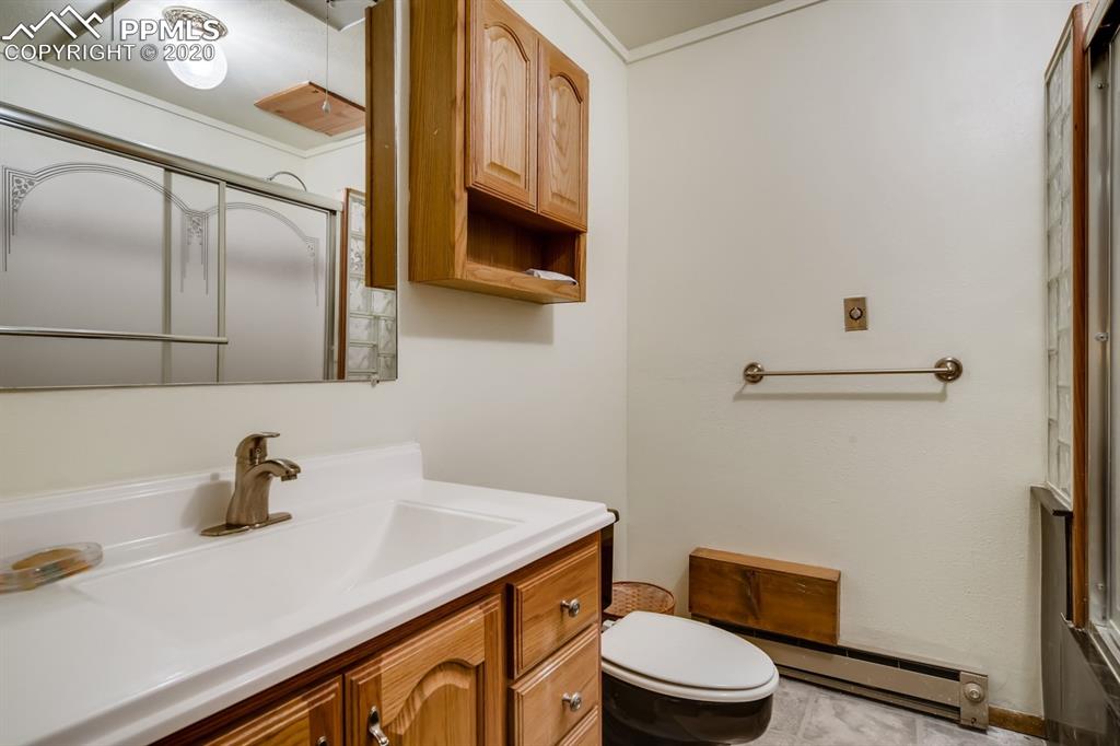 247 Pinewood Road Florissant, CO 80816 - Photo 18 of 39 a bathroom with a sink a toilet and mirror