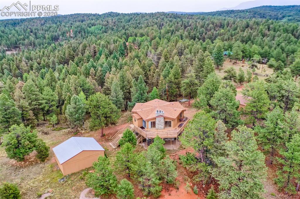 247 Pinewood Road Florissant, CO 80816 - Photo 37 of 39 an aerial view of a house with a lush green forest