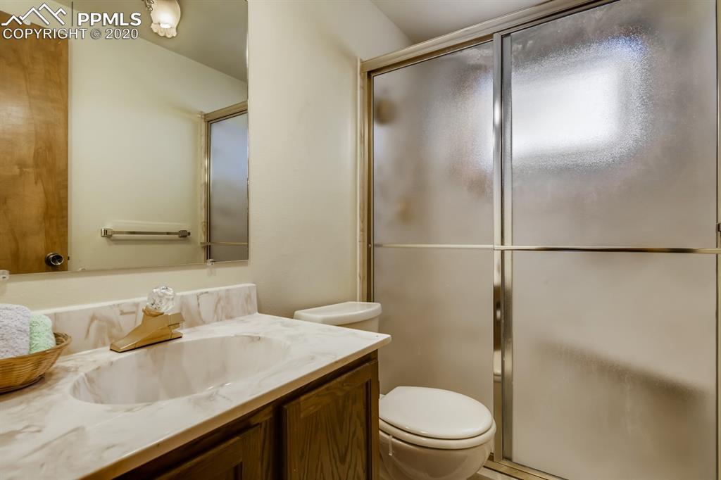 247 Pinewood Road Florissant, CO 80816 - Photo 6 of 39 a bathroom with a granite countertop sink toilet and shower