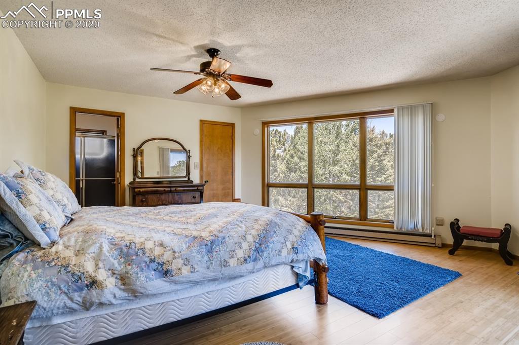 247 Pinewood Road Florissant, CO 80816 - Photo 7 of 39 a bedroom with a large bed and a large window