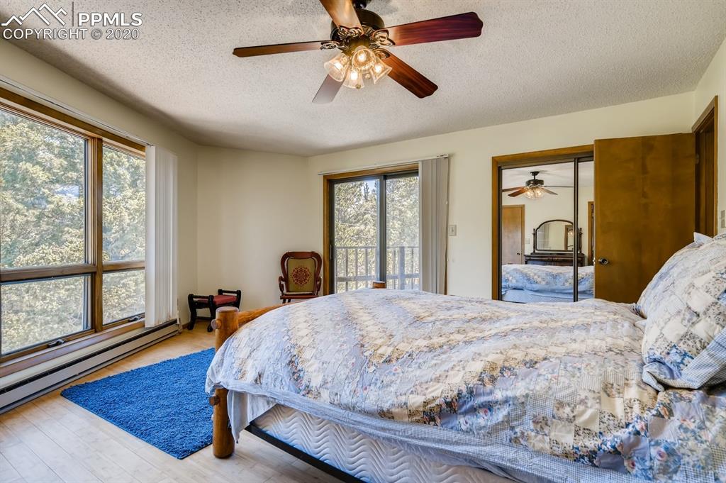 247 Pinewood Road Florissant, CO 80816 - Photo 8 of 39 a bedroom with a large bed and a large window