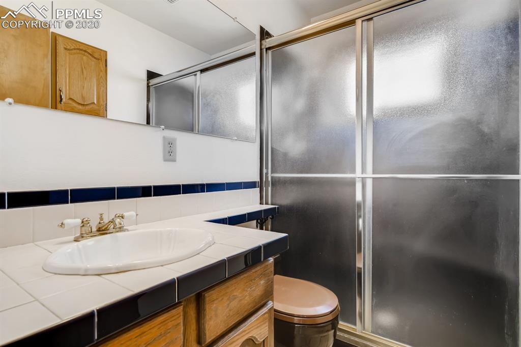 247 Pinewood Road Florissant, CO 80816 - Photo 9 of 39 a bathroom with a sink and a mirror