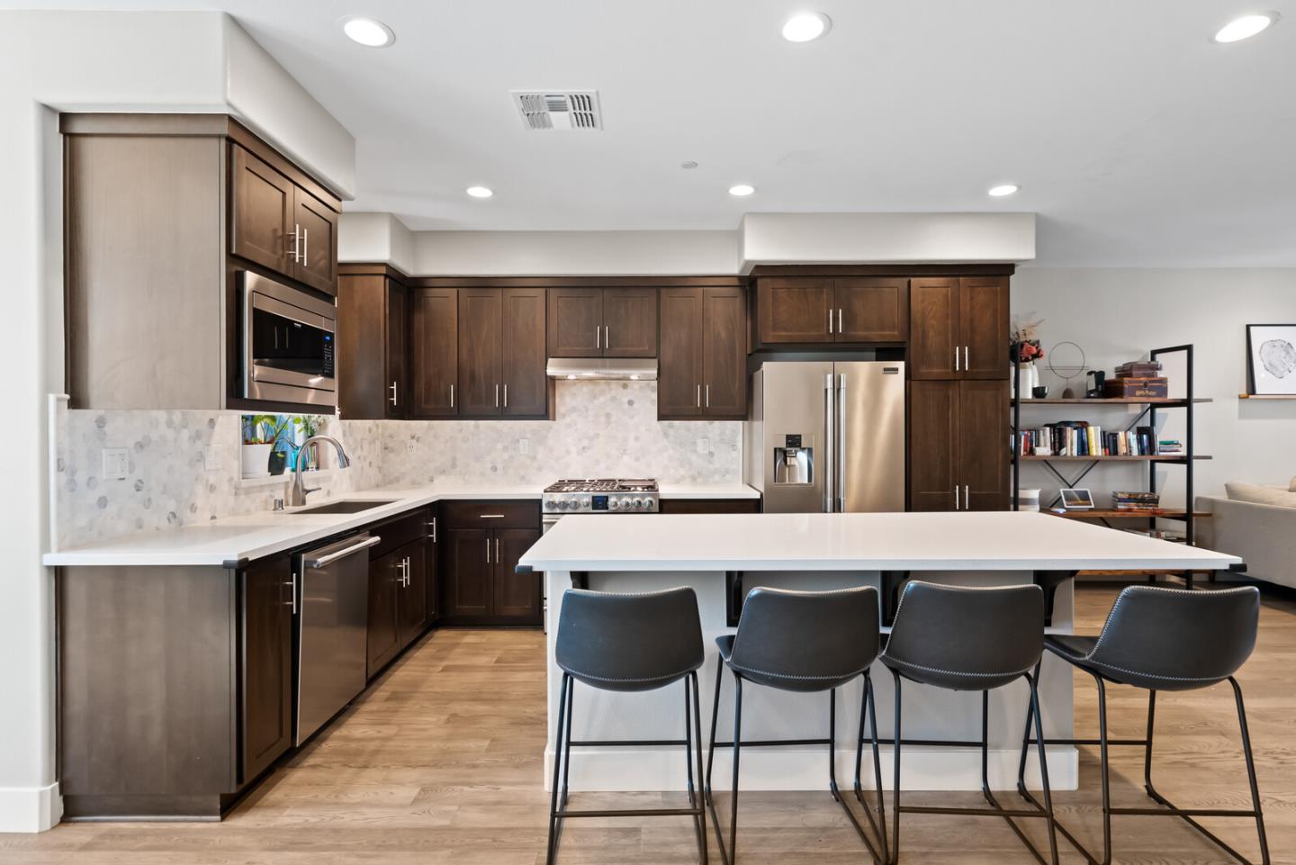202 Malley Way Campbell, CA 95008 - Photo 14 of 29 a kitchen with stainless steel appliances a dining table chairs refrigerator and microwave