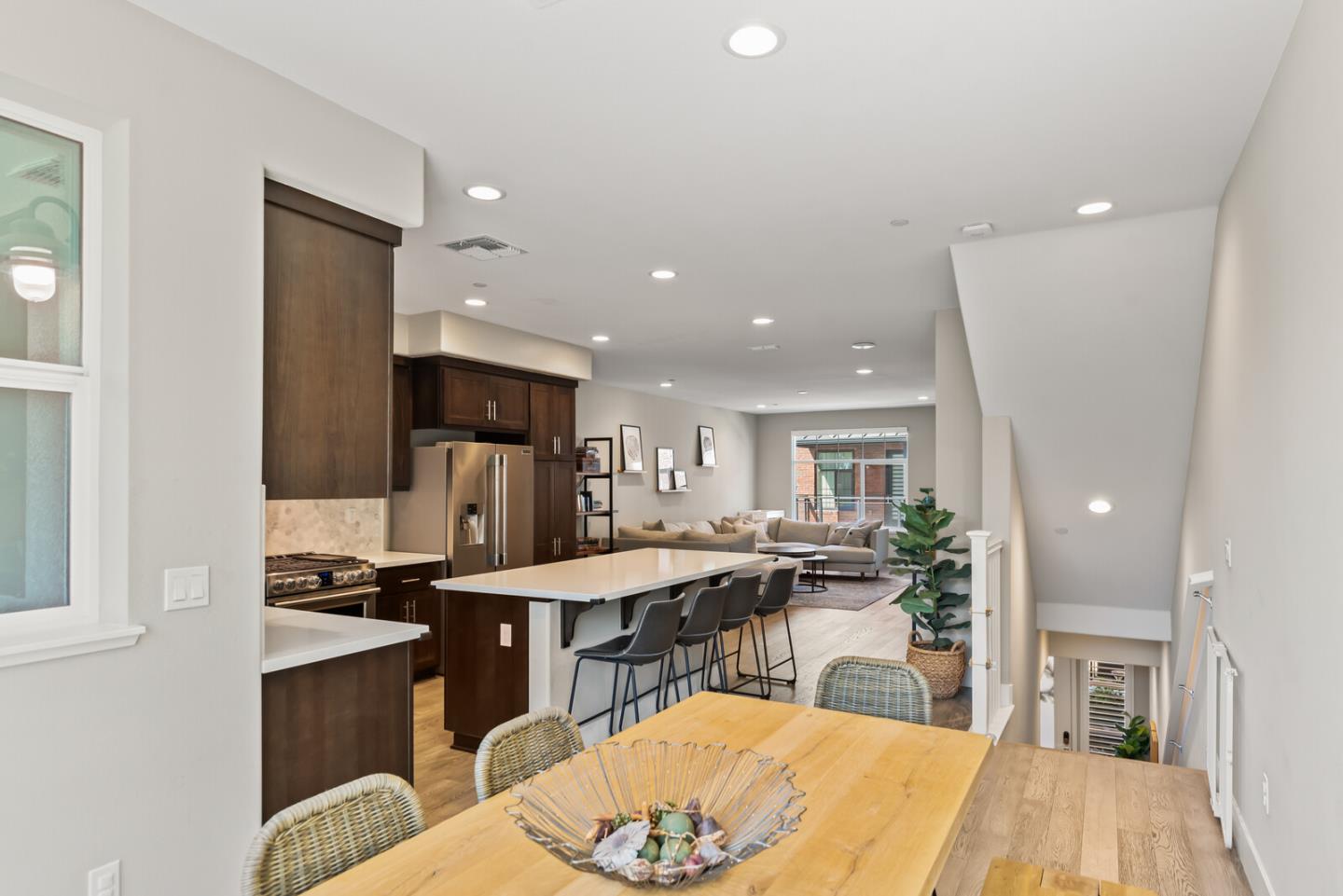 202 Malley Way Campbell, CA 95008 - Photo 20 of 29 a kitchen with stainless steel appliances kitchen island granite countertop a stove a refrigerator a sink a dining table and chairs with wooden floor