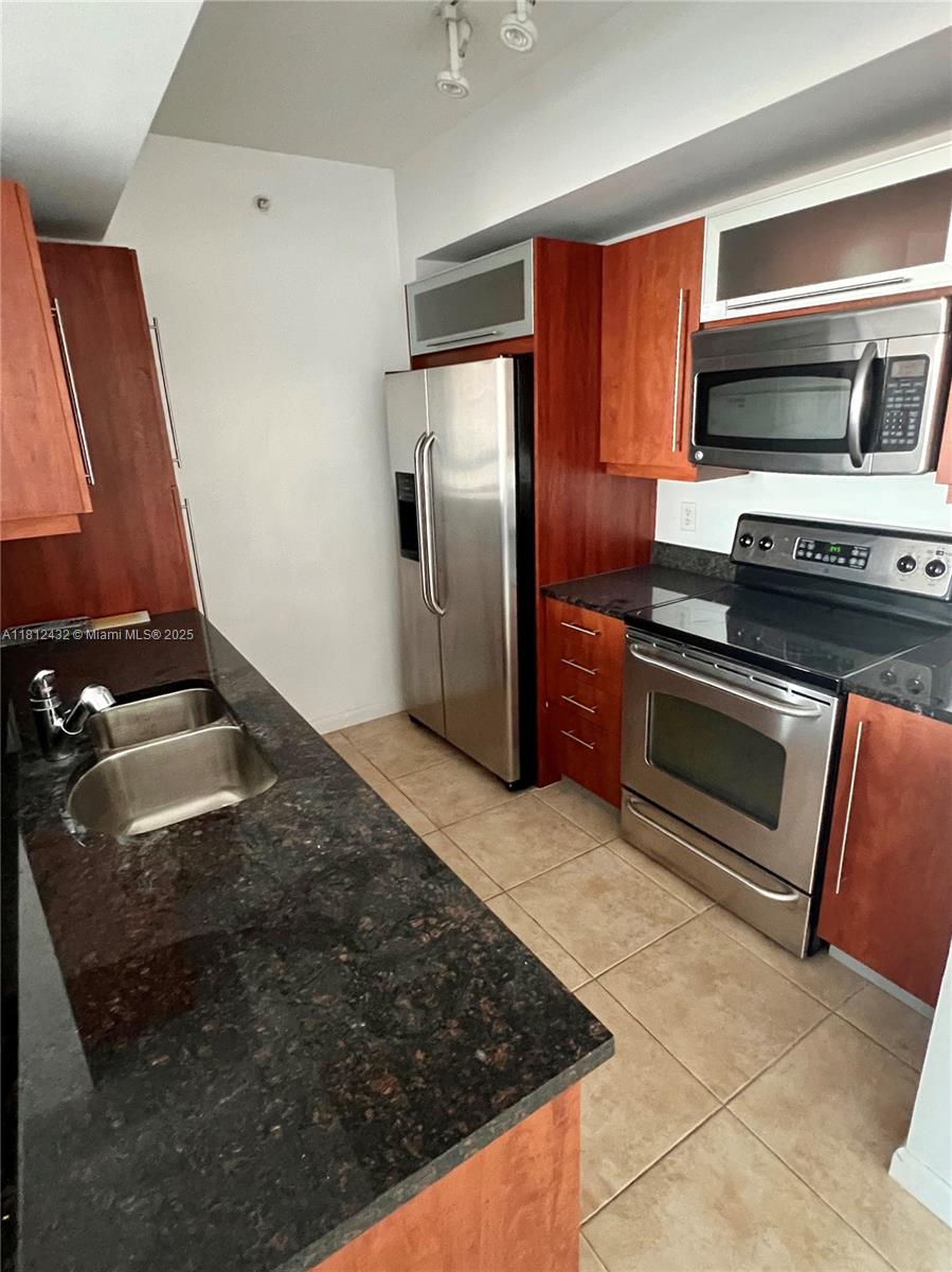 Kendall Miami, FL 33156 - Photo 12 of 22 a kitchen with stainless steel appliances granite countertop a refrigerator and a stove top oven