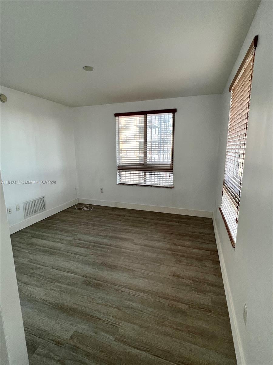 Kendall Miami, FL 33156 - Photo 17 of 22 an empty room with wooden floor and windows