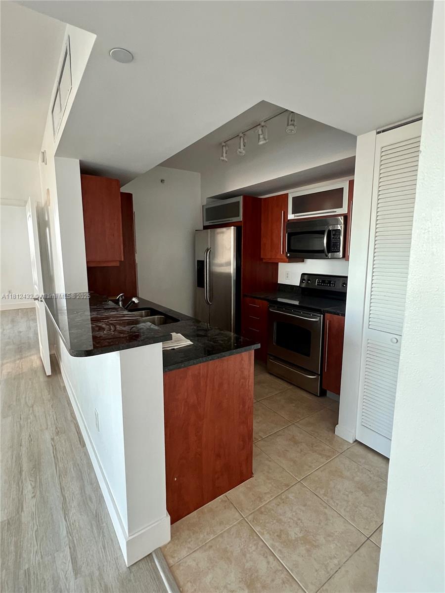 Kendall Miami, FL 33156 - Photo 10 of 22 a kitchen with stainless steel appliances a refrigerator and a stove top oven