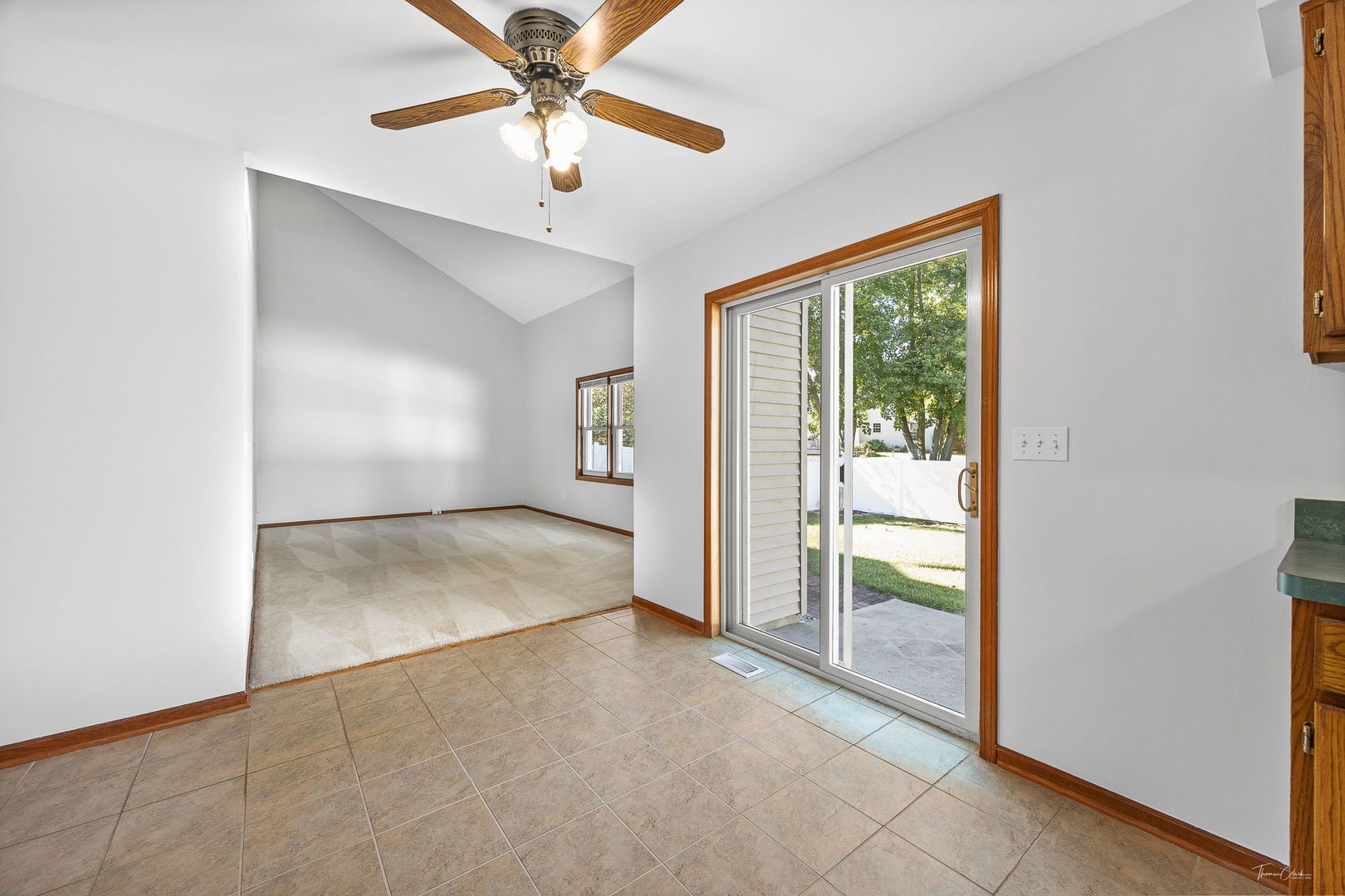 703 Avondale Lane Aurora, IL 60504 - Photo 11 of 40 an empty room with chandelier fan and windows