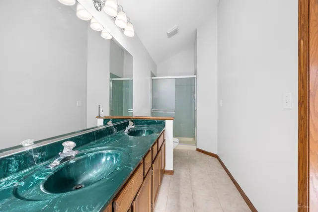 a bathroom with a granite countertop sink a mirror and vanity