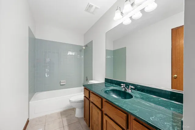 a bathroom with a sink a toilet and a large mirror