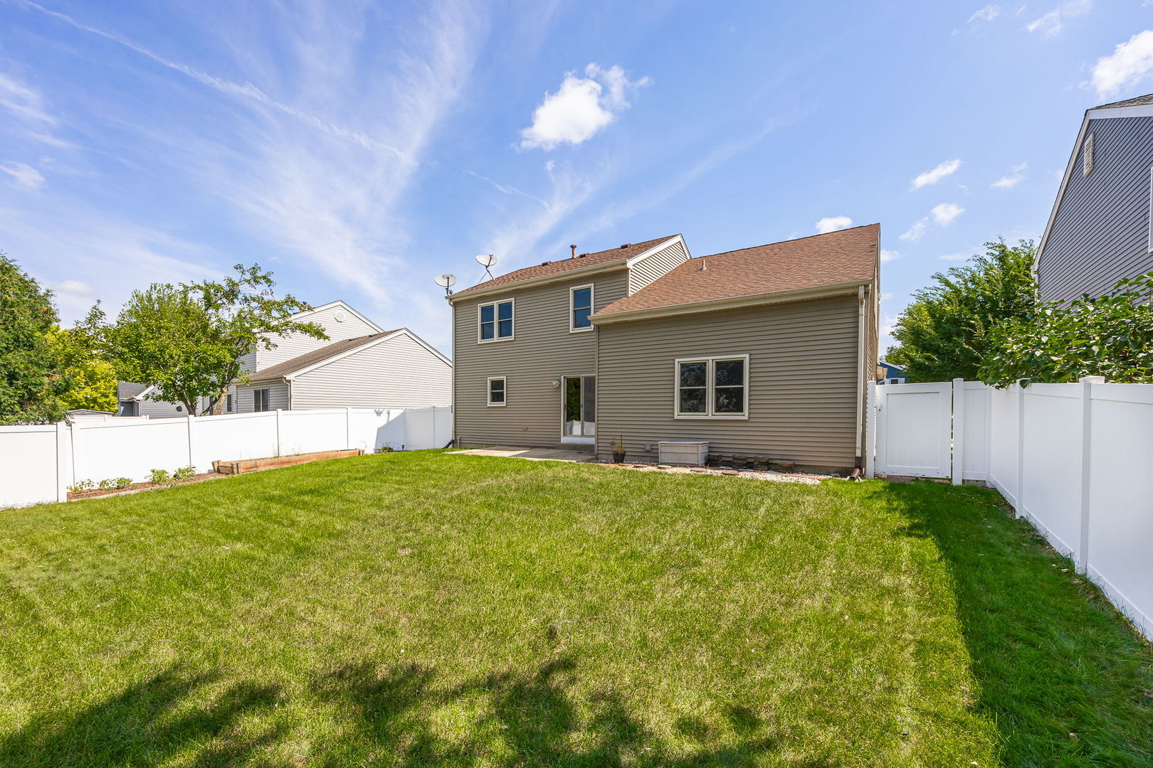 703 Avondale Lane Aurora, IL 60504 - Photo 31 of 40 a backyard of a house with plants and a yard