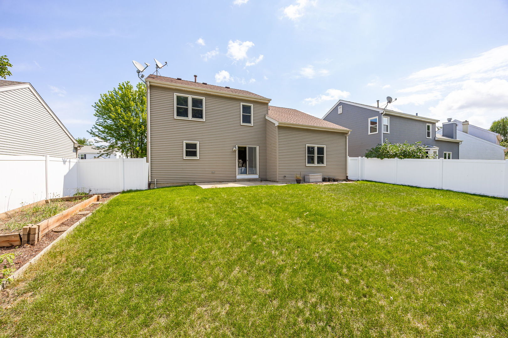 703 Avondale Lane Aurora, IL 60504 - Photo 32 of 40 a front view of house with yard and trees in the background