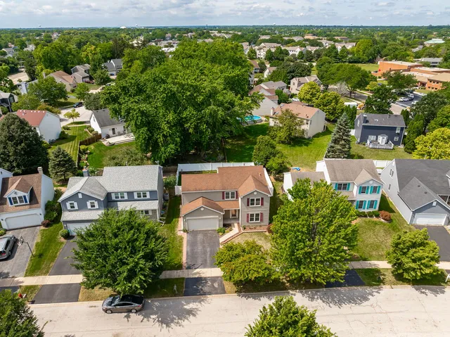 an aerial view of residential houses with outdoor space and street view