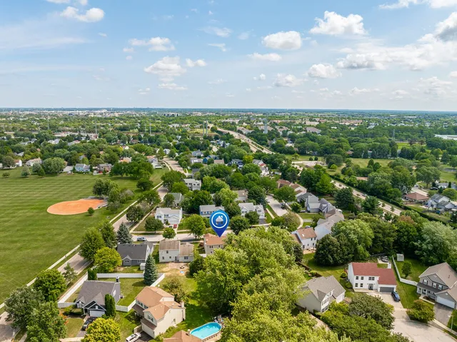 an aerial view of residential houses with outdoor space and swimming pool