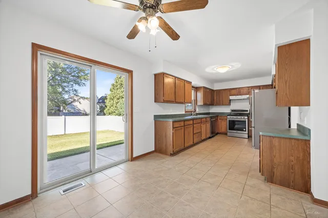 a view of a kitchen with a sink cabinets and outdoor space