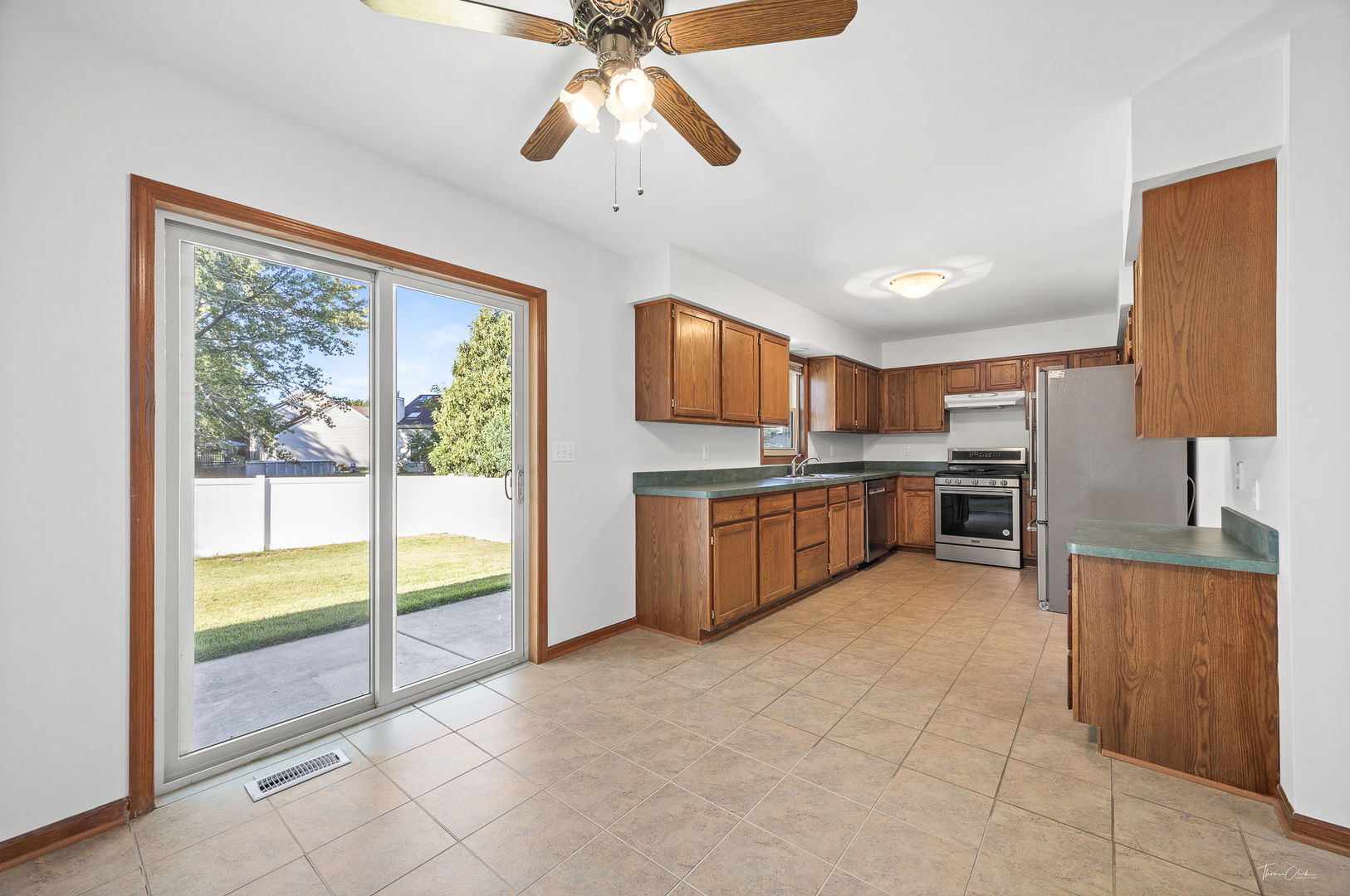 703 Avondale Lane Aurora, IL 60504 - Photo 8 of 40 a view of a kitchen with a sink cabinets and outdoor space