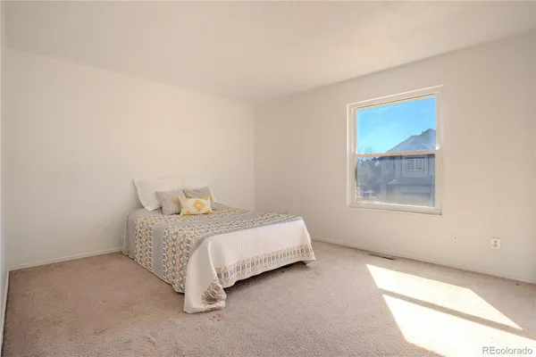 a room with a bed and a window