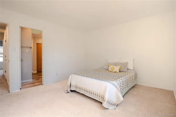 a bedroom with a bed and a night stand