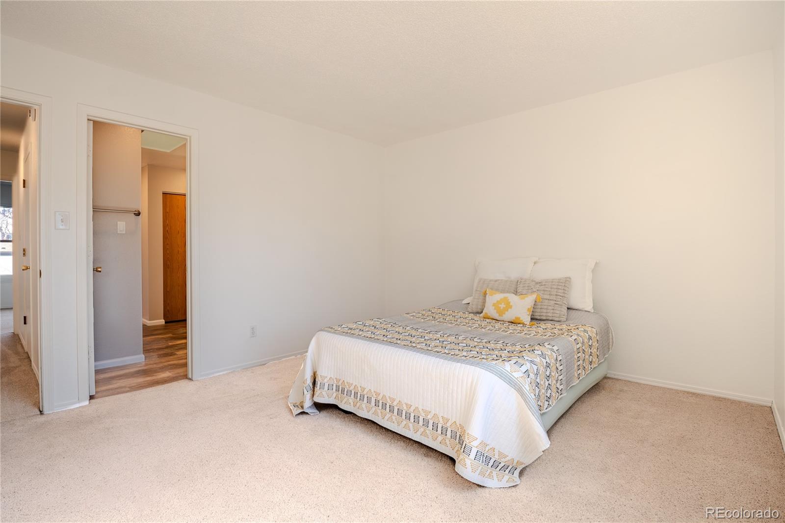 6315 Oak Street, Unit 2 Arvada, CO 80004 - Photo 14 of 34 a bedroom with a bed and a night stand