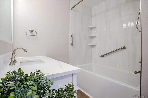 a bathroom with a bathtub and shower