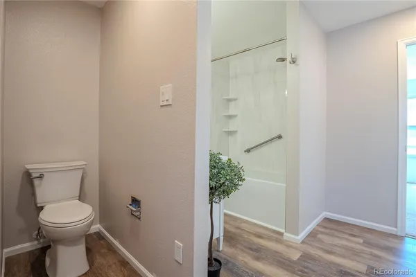 a bathroom with a toilet and a shower