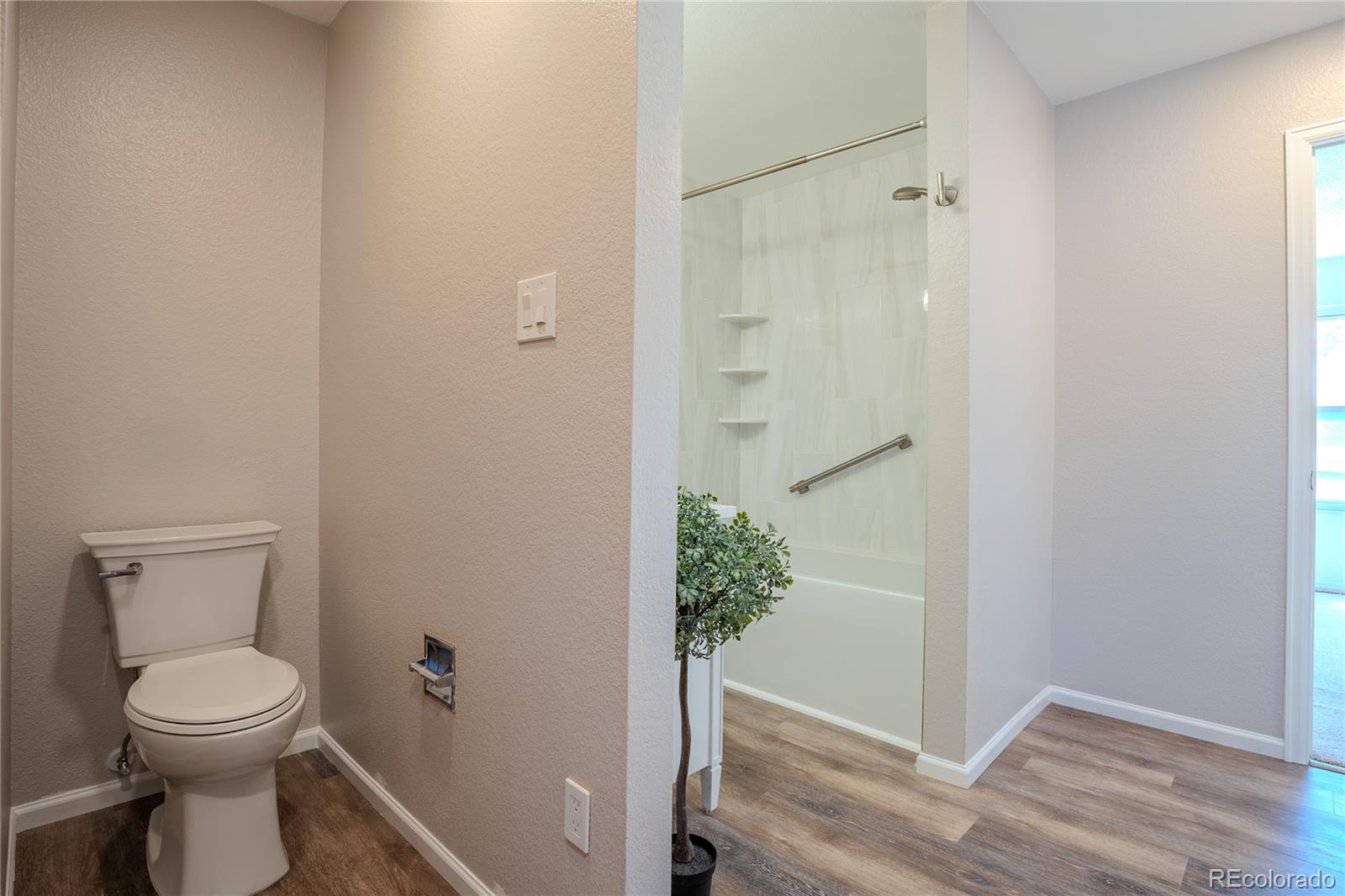 6315 Oak Street, Unit 2 Arvada, CO 80004 - Photo 18 of 34 a bathroom with a toilet and a shower