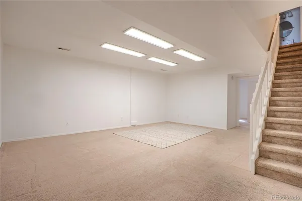 a view of an empty room with stairs