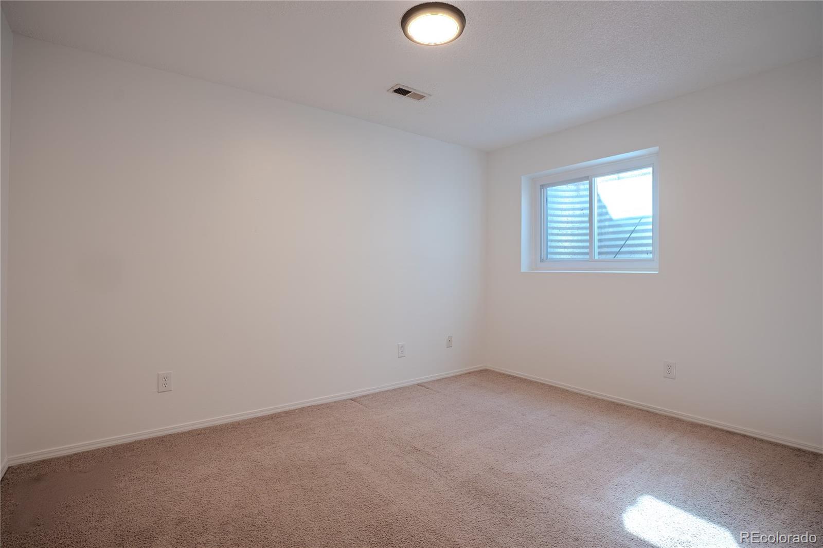 6315 Oak Street, Unit 2 Arvada, CO 80004 - Photo 23 of 34 an empty room with a window