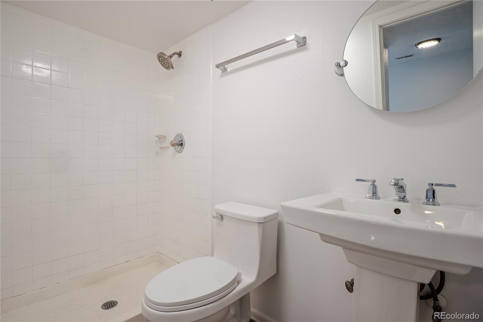 6315 Oak Street, Unit 2 Arvada, CO 80004 - Photo 25 of 34 a bathroom with a sink a toilet and shower