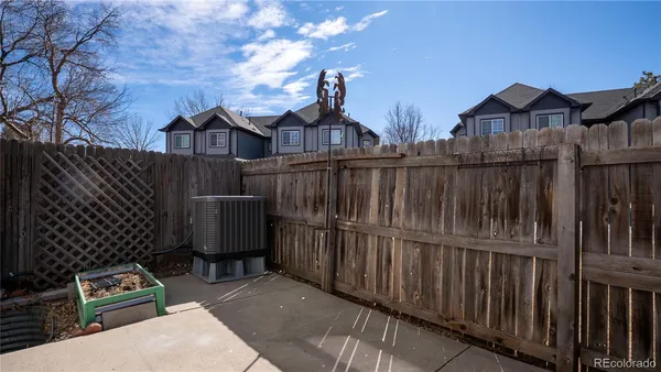 a view of a house with a wooden fence