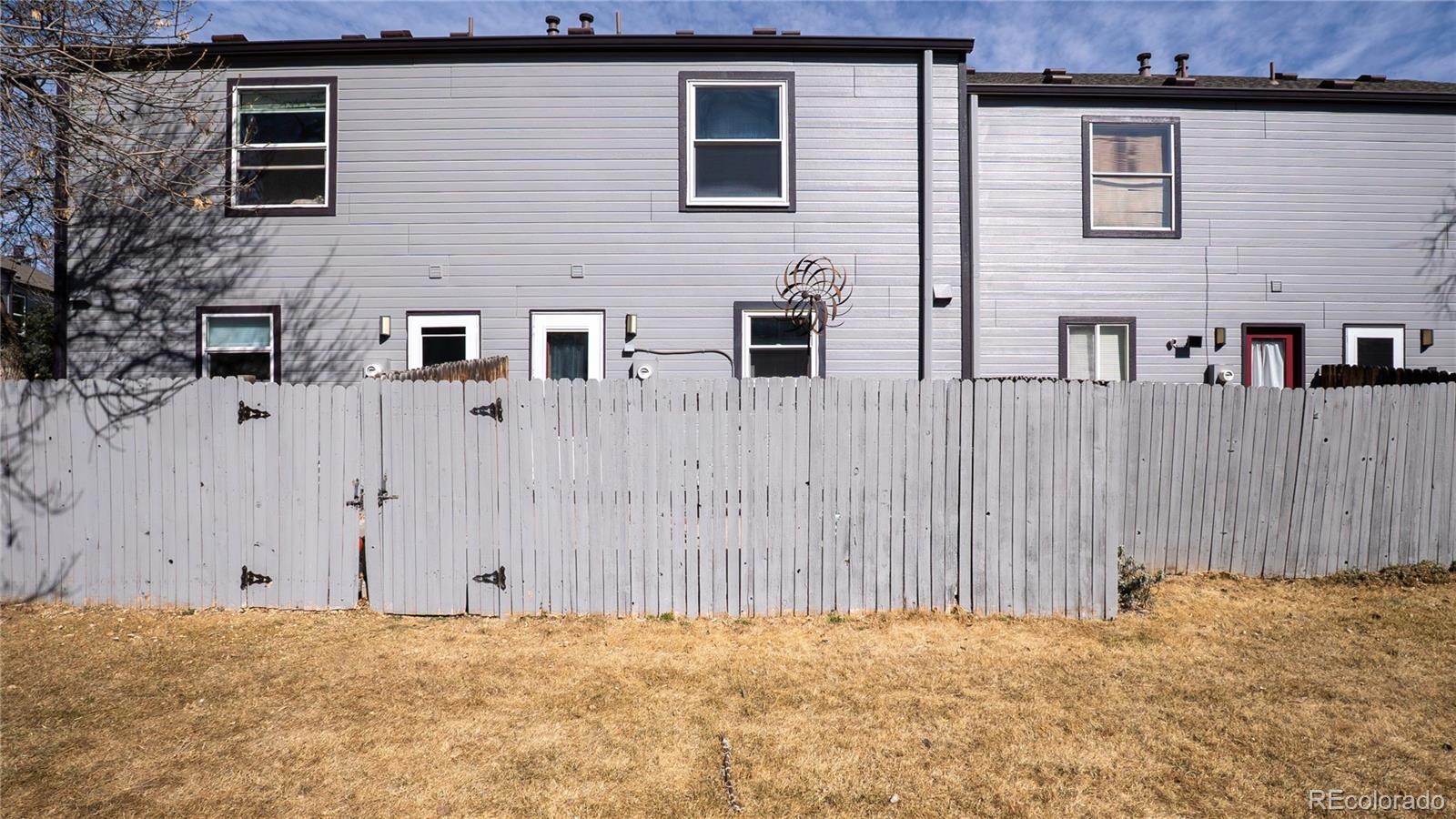 6315 Oak Street, Unit 2 Arvada, CO 80004 - Photo 28 of 34 a view of a house with a wooden fence
