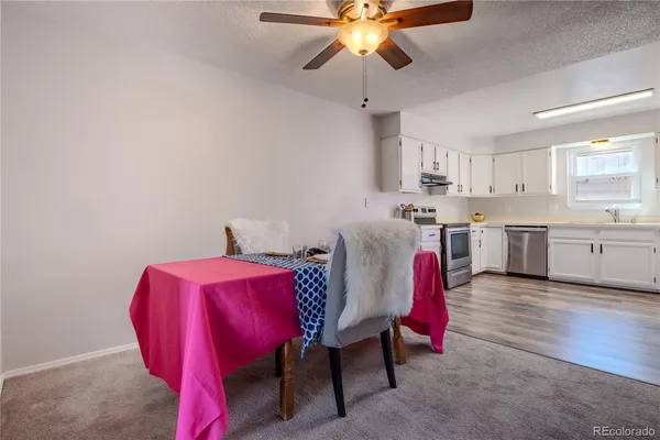 a living room with furniture and kitchen view
