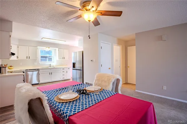 a living room with furniture and a dining table