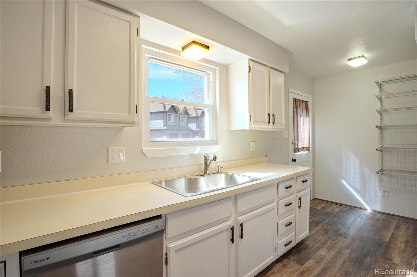 6315 Oak Street, Unit 2 Arvada, CO 80004 - Photo 7 of 34 a kitchen with a sink and cabinets