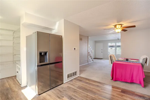 a view of a bedroom with bed cabinet and hallway